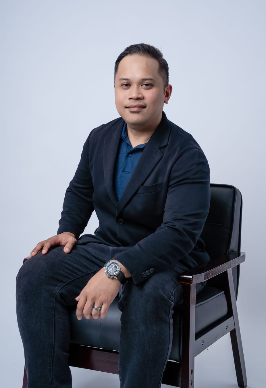 Husaini Salamat, seated studio portrait.
